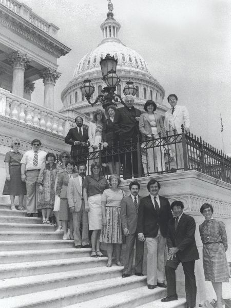 The group poses for a photo on the steps at the U.S. Capitol