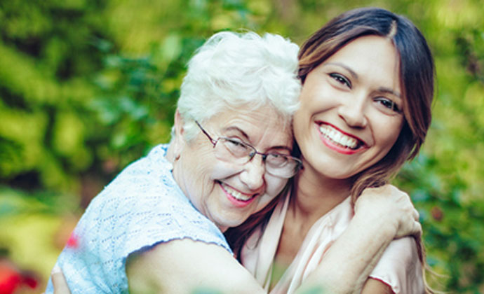 Elderly woman with younger caregiver