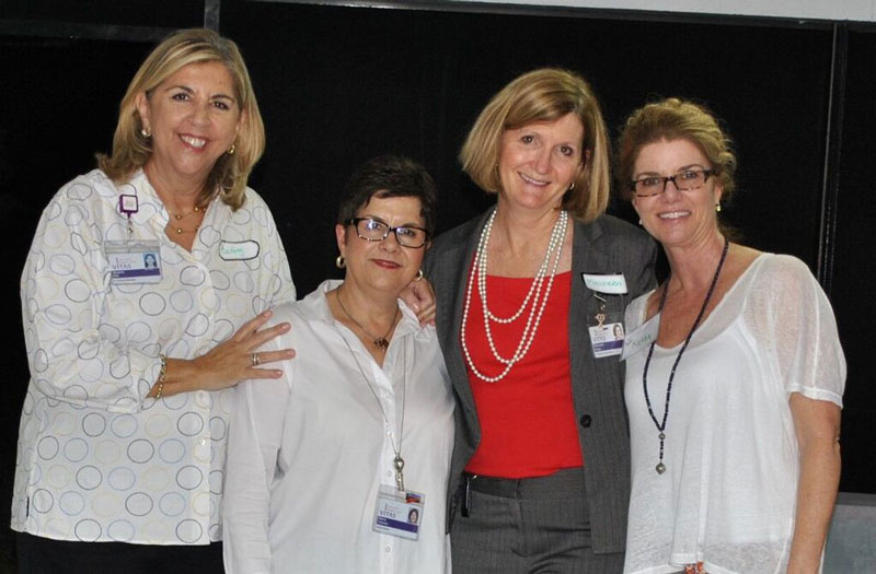 The group of four women smiles at the event