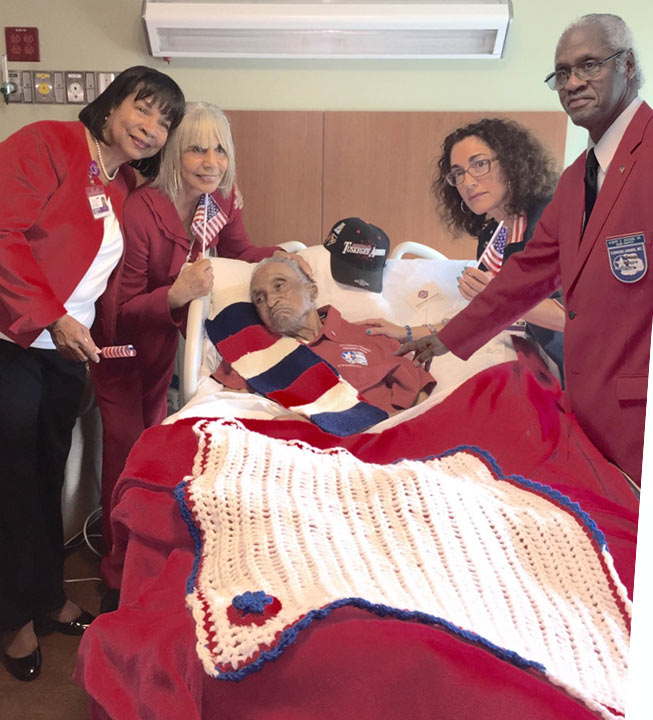 A bedside salute for Lt. Col. Williams at University of VITAS hospice inpatient unit at Miami Hospital.