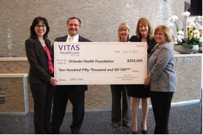 The group holds a ceremonial oversized check