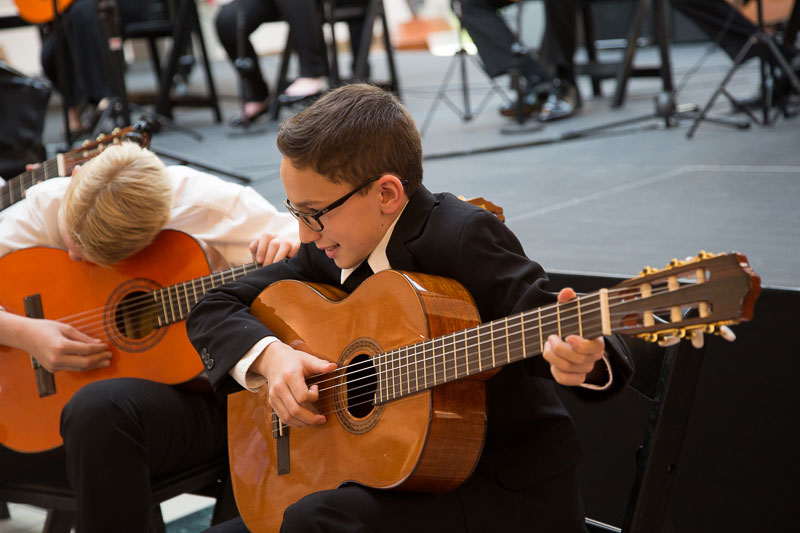 Two children play guitars