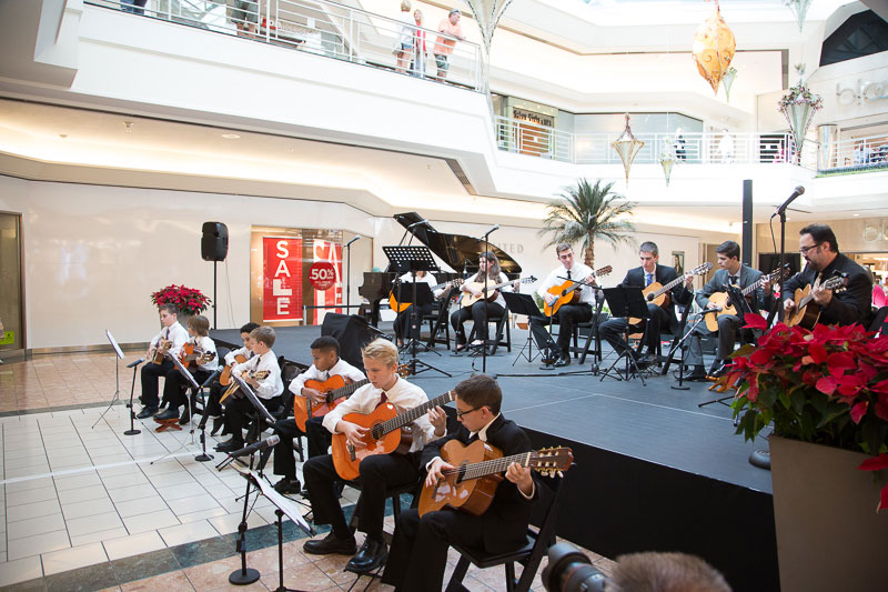 The adult and child musicians perform together