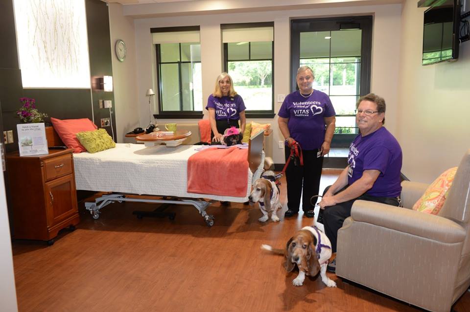 Three Pet Paws volunteers with their dogs, two beagles and a toy breed