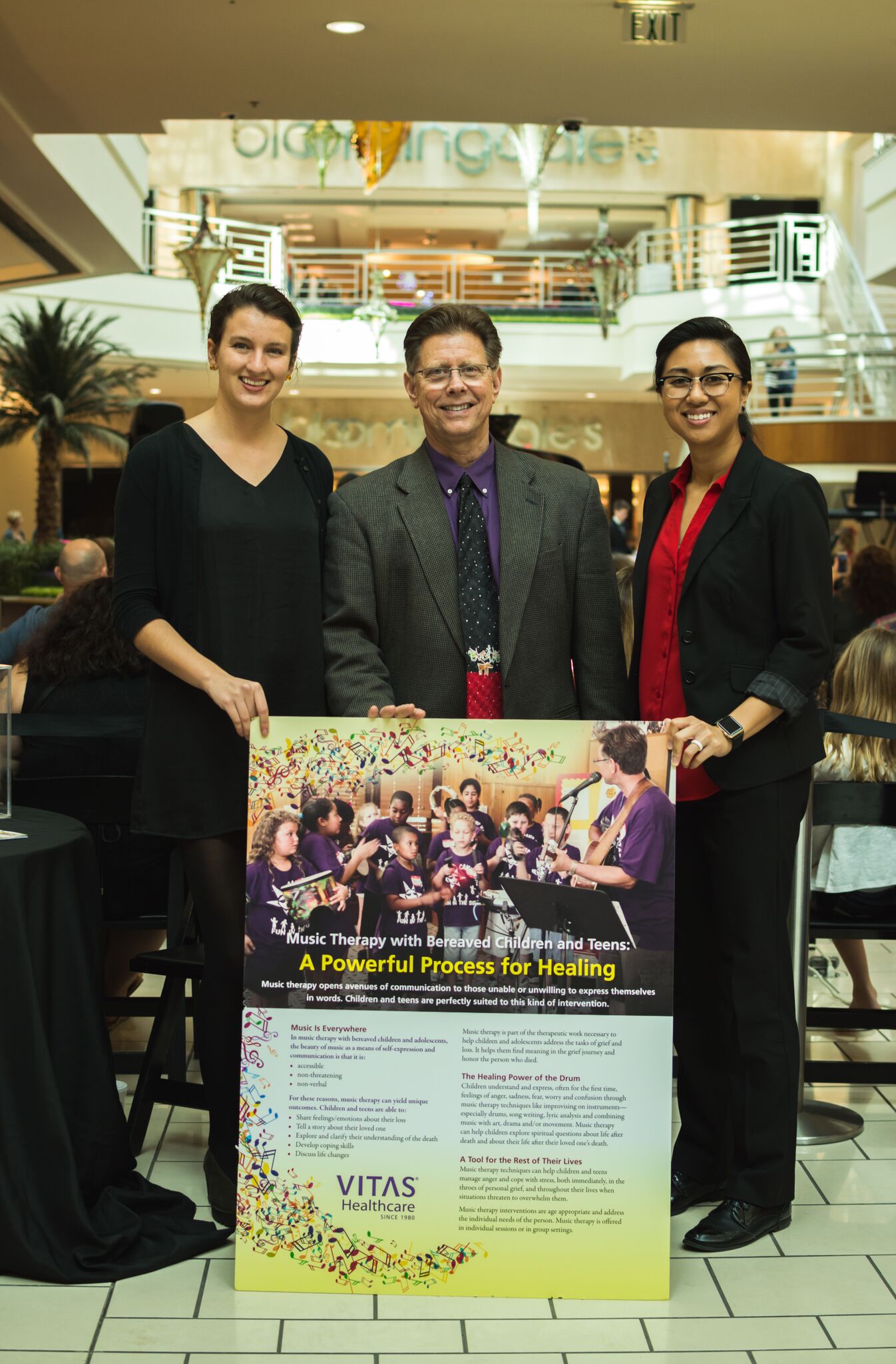 Dalton and two others pose with the event flyer