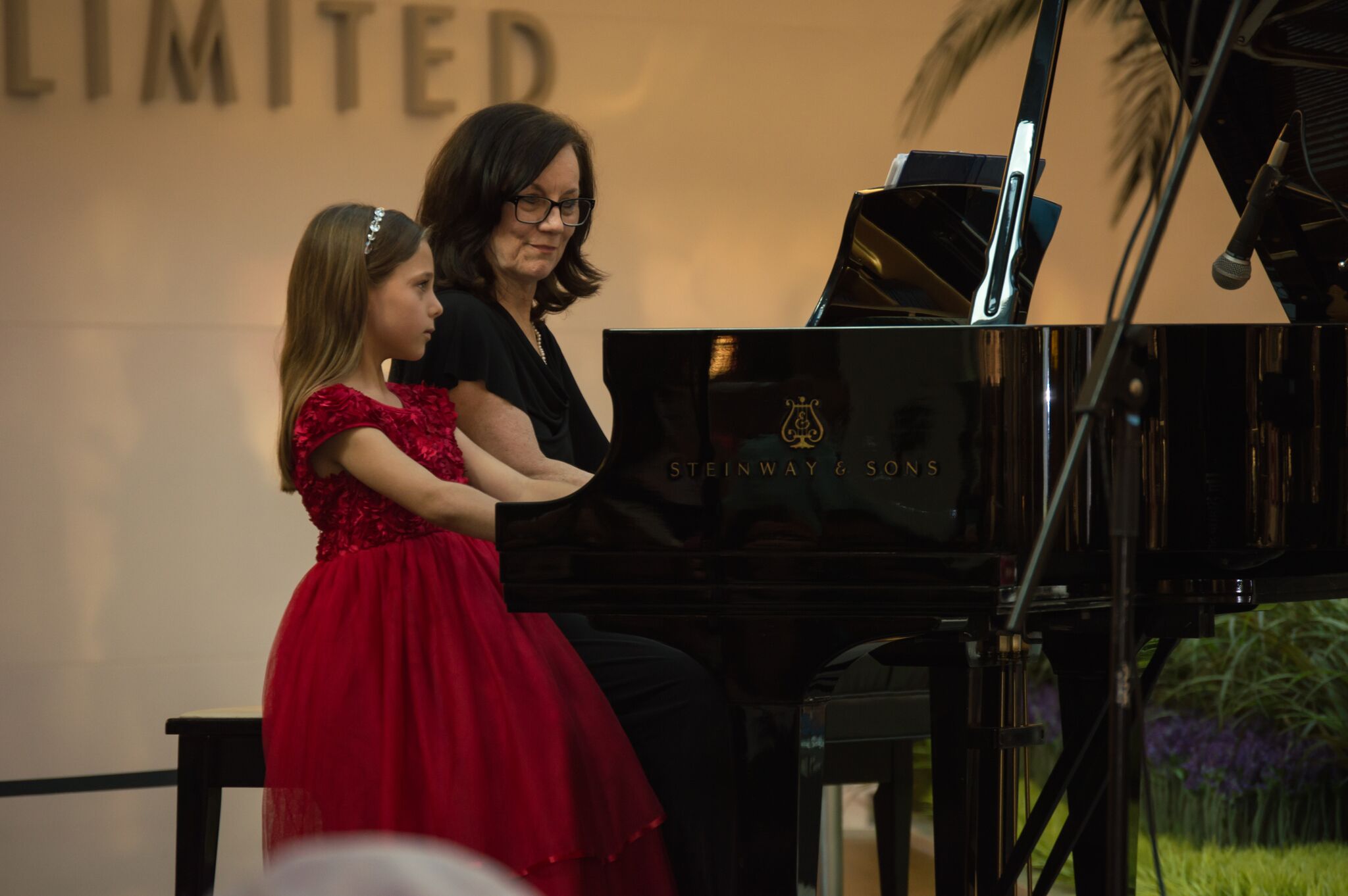 A young woman plays piano