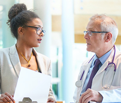 A case manager talks with a physician