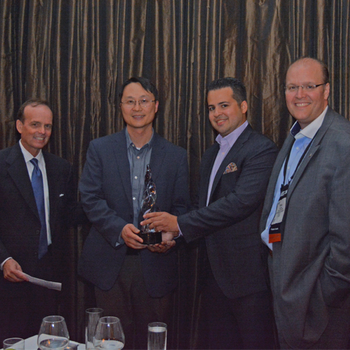 The group poses with the award