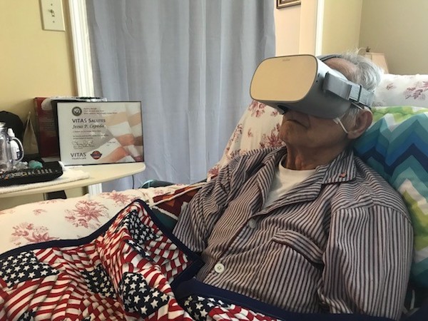 Cepeda wears the virtual reality goggles in bed