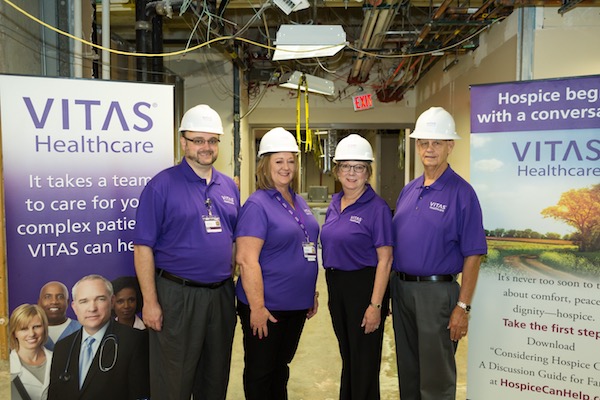 The team poses in construction hardhats