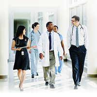 A group of physicians walks down a corridor at a hospital
