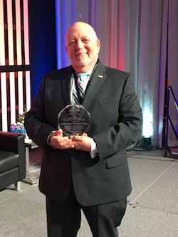 Dr. Policzer holds the award