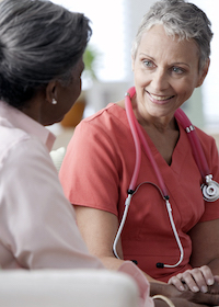 A nurse talks with a patient