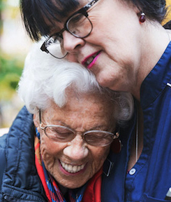 A patient embraces a nurse