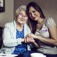 A patient holds hands with a social worker