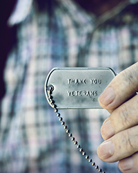 A military dog tag that says Thank You Veterans