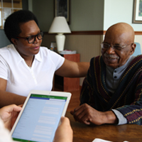 A caseworker talks with a patient