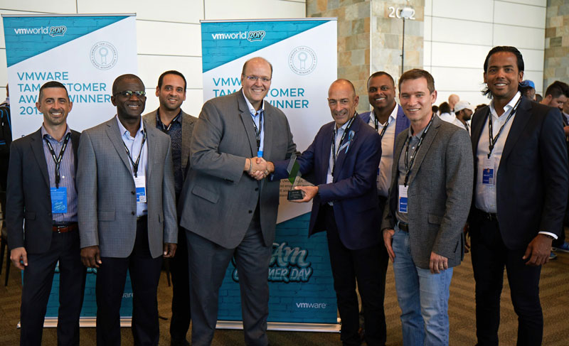 The group poses for a photo with the award