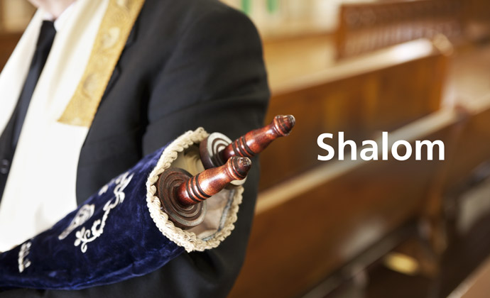 A graphic with a Torah scroll with the word "Shalom"