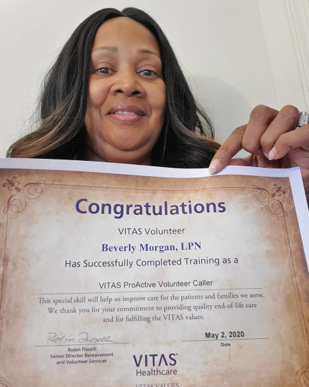 Beverly Morgan holds her volunteer training certificate