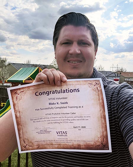 Blake Smith holds his volunteer training certificate
