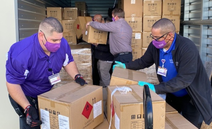 VITAS HME team members unload boxes of supplies from a truck