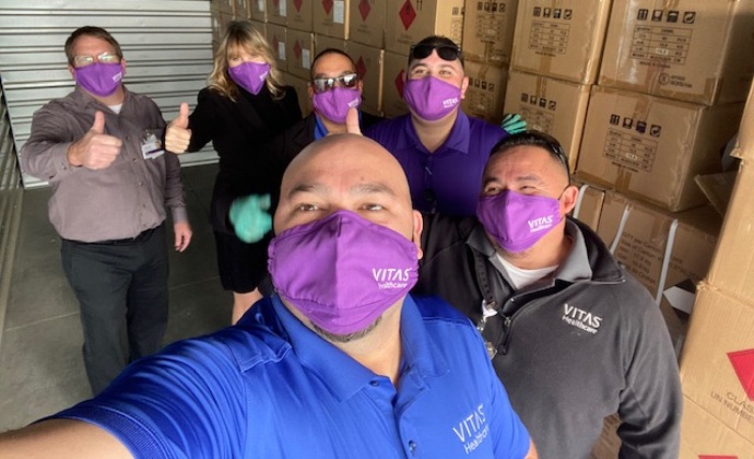 VITAS HME team members pose for a selfie with a truckload of supplies