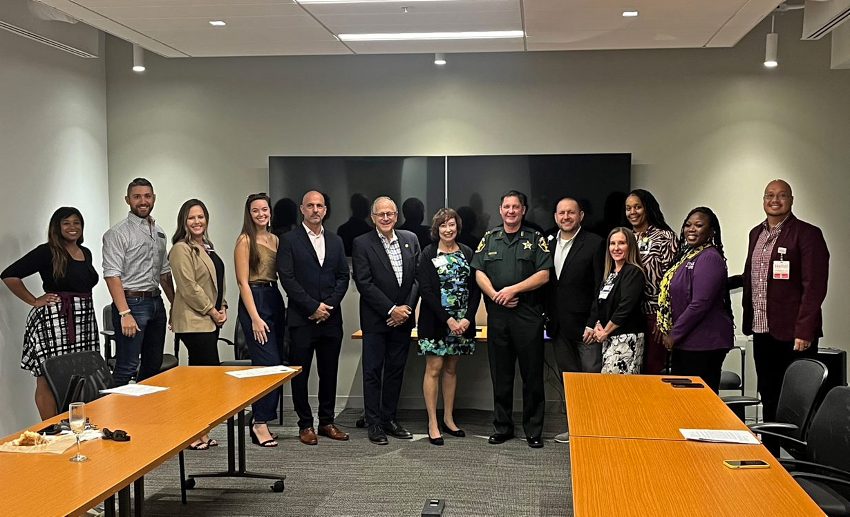 The group poses for a photo in the conference room