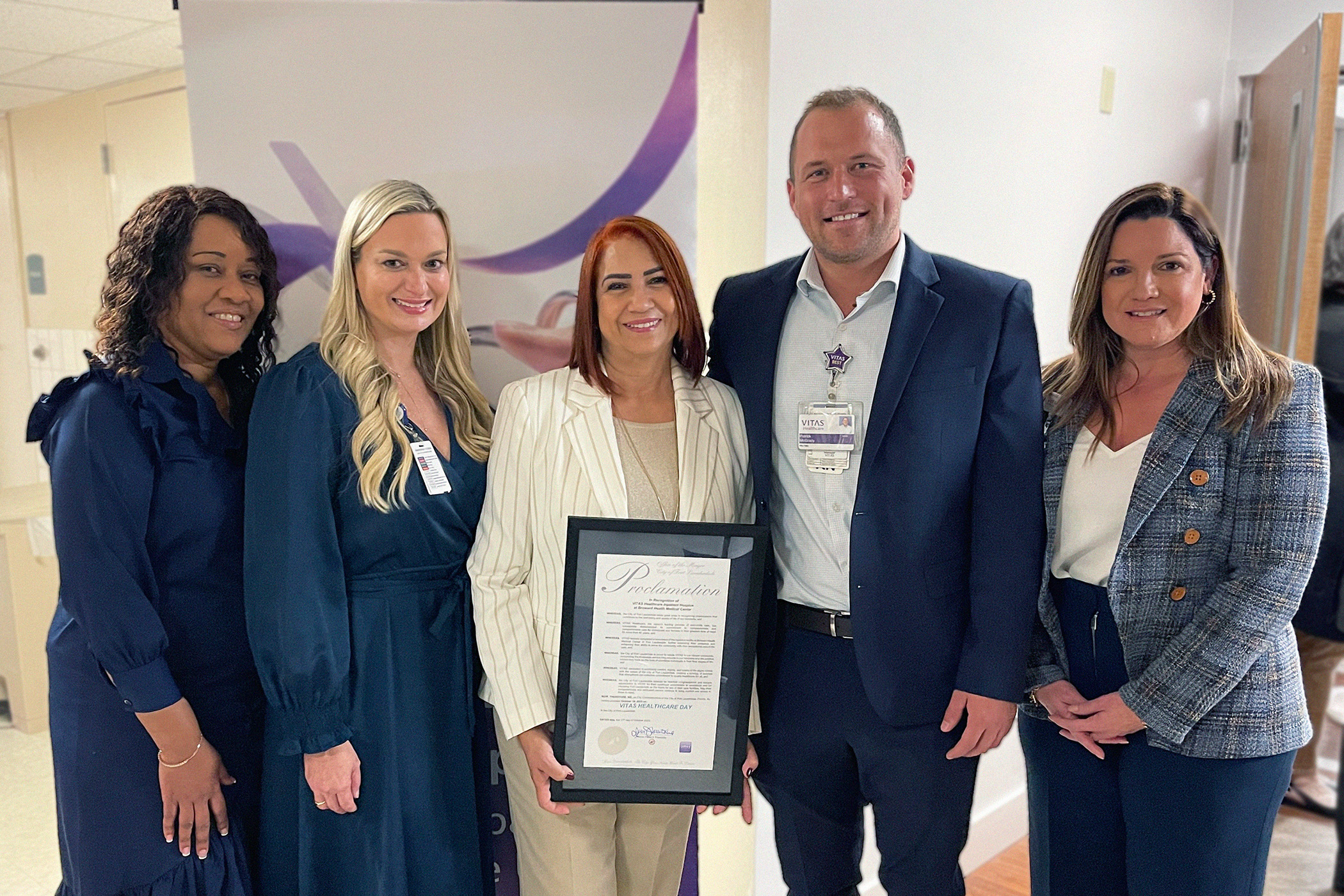 VITAS leaders hold a proclamation issued by the office of Fort Lauderdale Mayor Dean J. Trantalis recognizing October 19, 2023, as VITAS Healthcare Day. From left: Donna Borland, general manager; Kathleen Coronado, senior general manager; Silvia Tapanes, team manager; Patrick McGrady, senior patient care administrator; and Natalia Hernandez, vice president of operations.