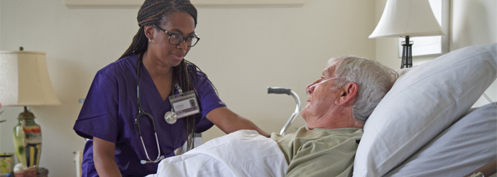 VITAS Nurse cares for bedridden patient