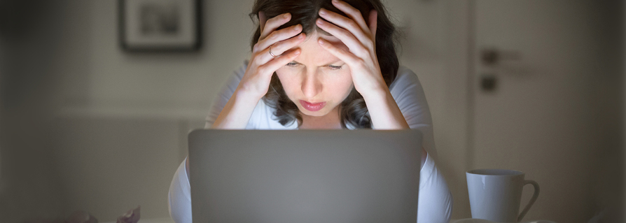 Woman frustrated looking at her computer