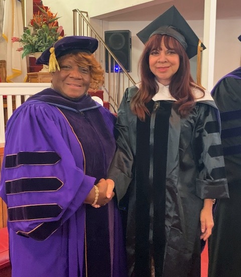 Dr. Blanche Davis and Maria Hidalgo, both in caps and gowns