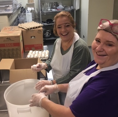 San Antonio employees cracking eggs at Haven for Hope Food Bank