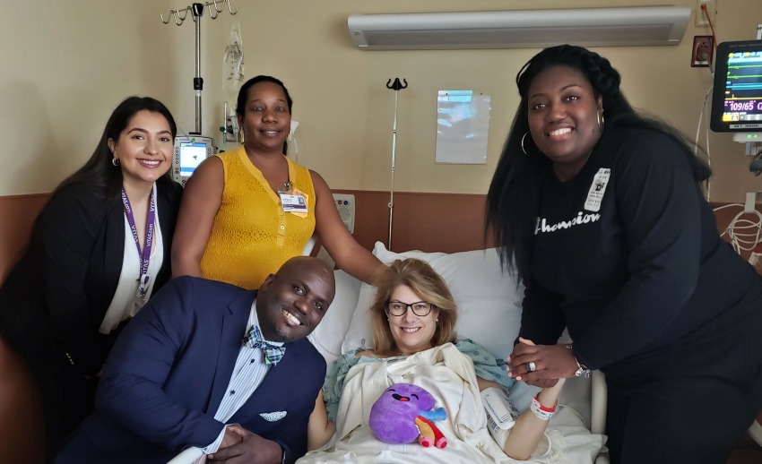 Claudine and other VITAS team members spend time with Amy in her hospital room