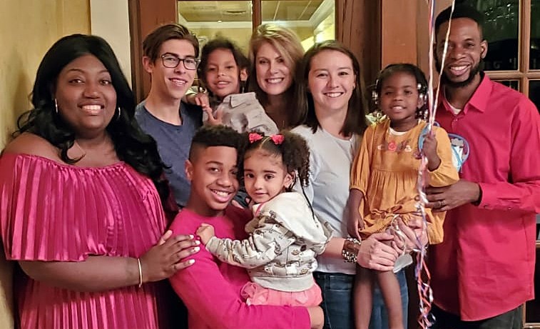 Amy and her family with Claudine, Junior and their family at a party before surgery