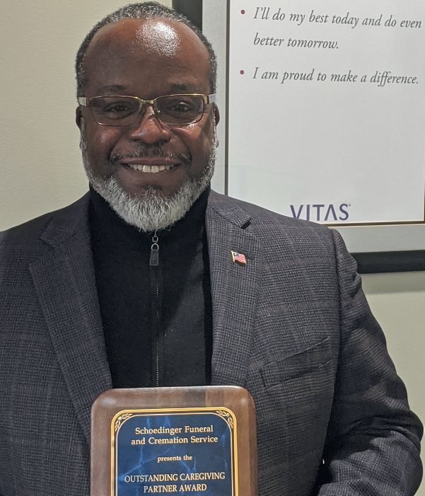 Mark Haynes holds a plaque commemorating his award