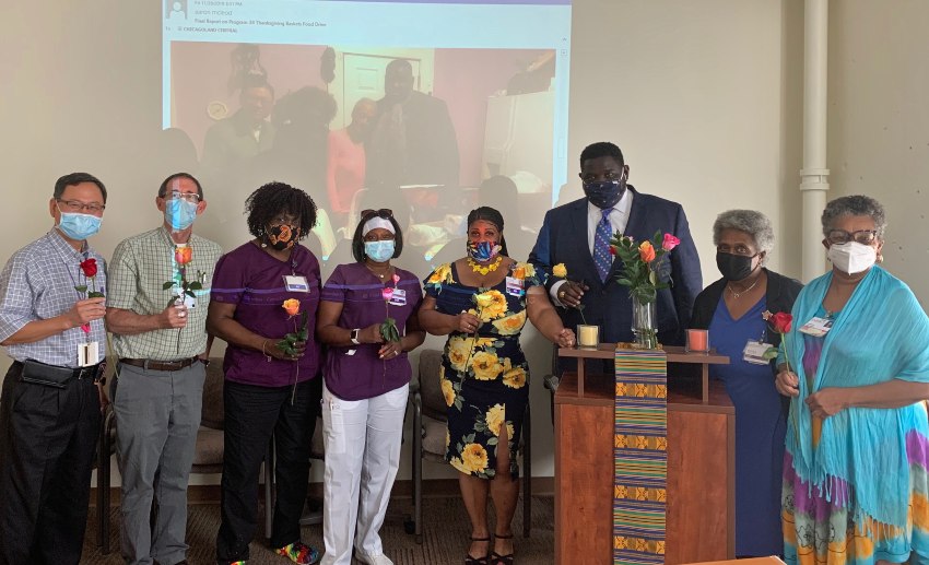 The VITAS team in Chicago that cared for Kimiko hold roses at a memorial service for their patient