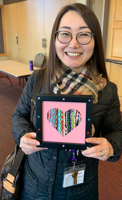 A member of the VITAS Sacramento Intensive Comfort Care team holds a heart award