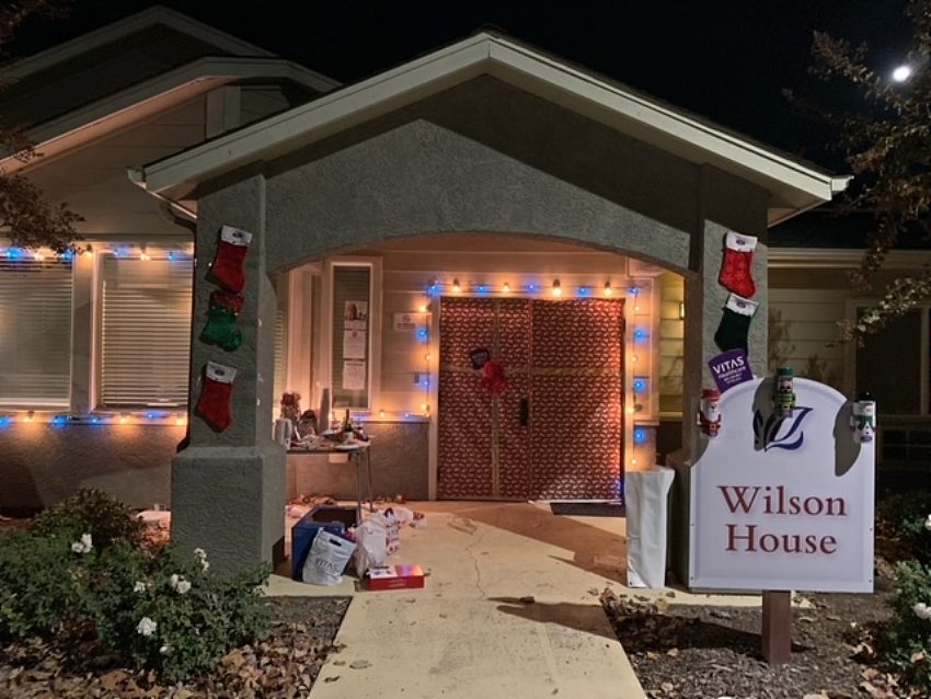 Exterior of Wilson House at night, with holiday lights shining brightly