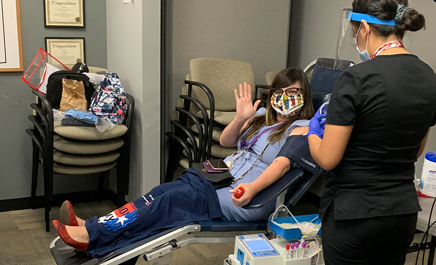 A VITAS employee donates blood at the program office