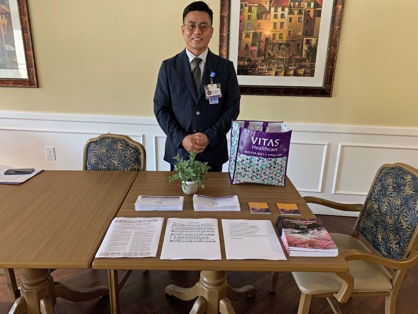 Eui Hong at a table with bereavement materials