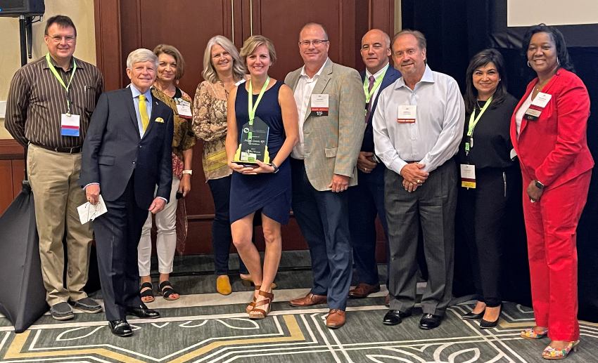 Andrea holds the award surrounded by board members of the Texas and New Mexico Hospice Organization