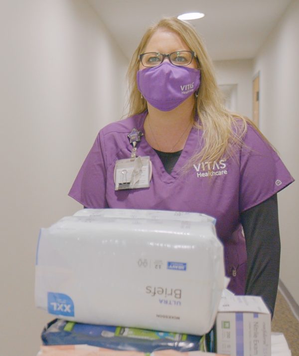 VITAS hospice aide with cart of supplies