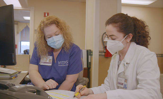 A VITAS nurse practitioner and VITAS physician review patient information