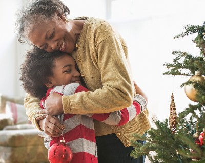A grandmother and granddaughter hug one another