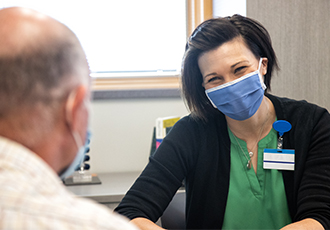 A VITAS team member talks with a patient's family member
