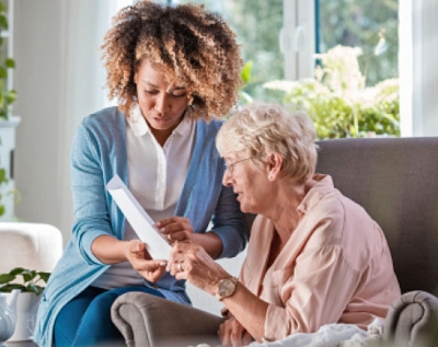 A hospice volunteer and a hospice patient read together