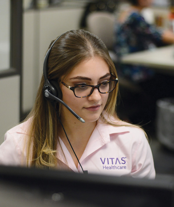 A VITAS team member answers a call