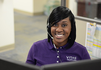 A VITAS customer service representative answers a telephone call