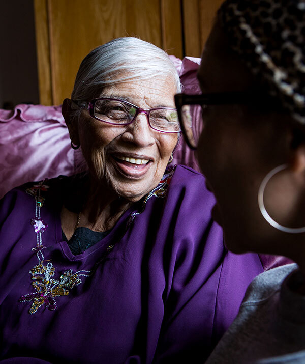 A woman talks with her daughter at home